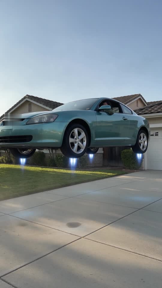 Driveway Liftoff example: a teal unbranded sedan lifts off a suburban driveway on blue thrusters beside a house and lawn